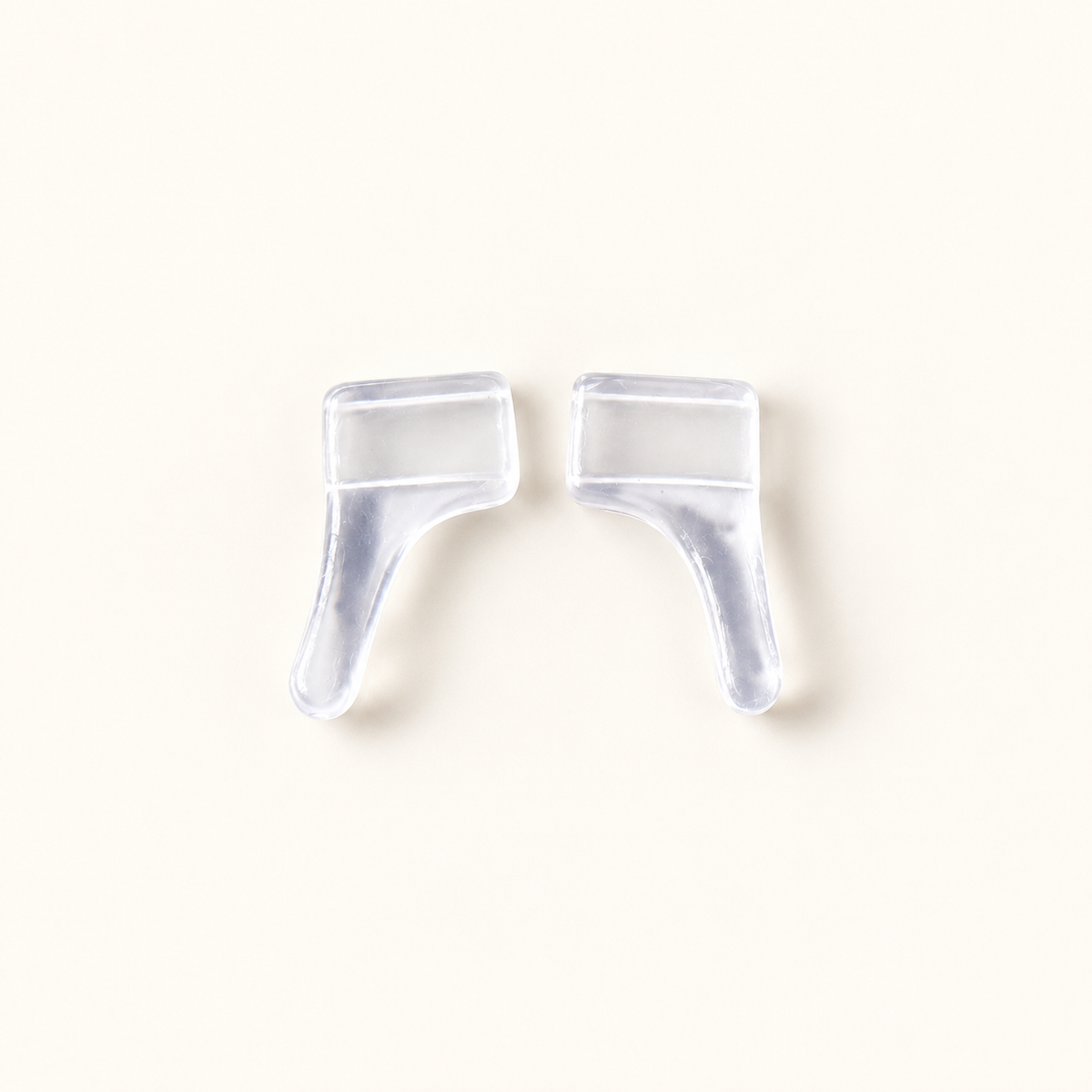 One pair of clear slip-on eyeglass ear grips in a representative profile